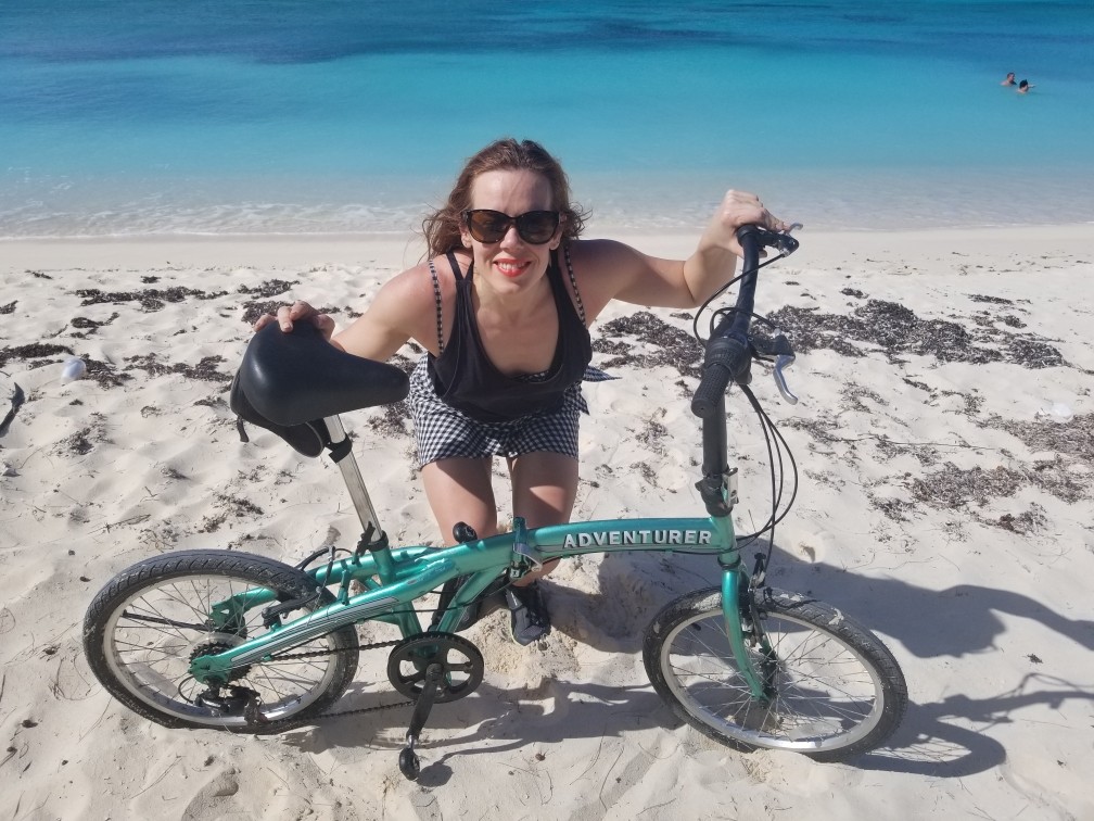 Lady with bicycle on beach