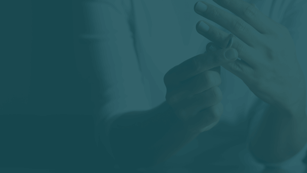 Close-up of hands removing a wedding ring