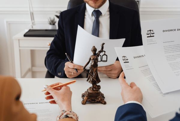 Divorce consultation with documents and Lady Justice statue in an attorney's office