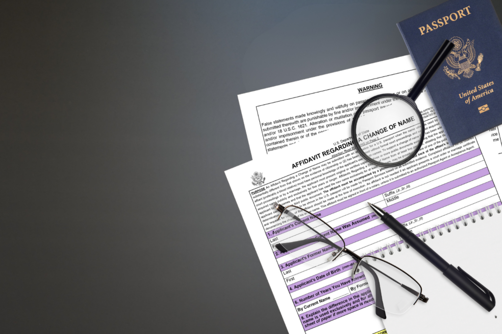 Legal documents, passport, and magnifying glass for a post-divorce name change