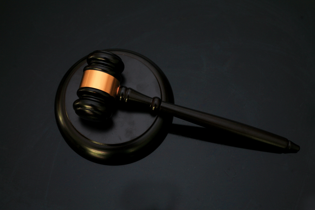 Judge's gavel on a dark surface, symbolizing authority and legal judgment.
