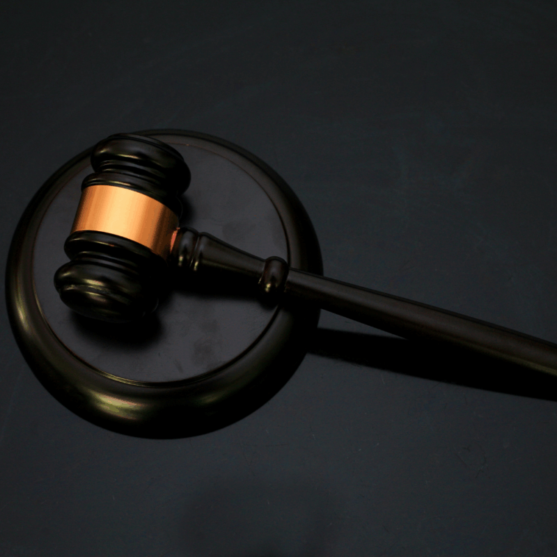 Judge's gavel on a dark surface, symbolizing authority and legal judgment.