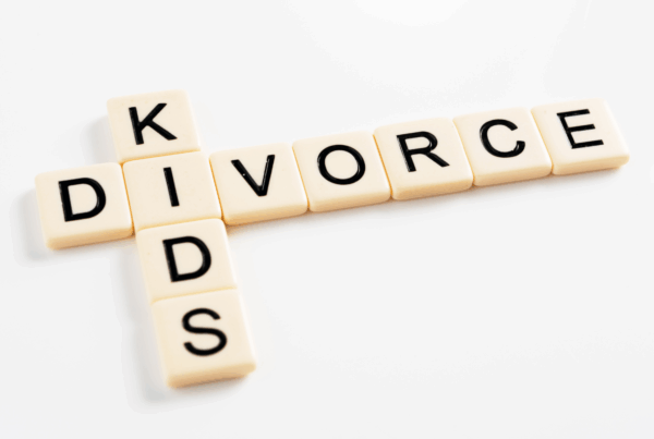 Divorce and kids spelled in tiles illustrating family separation
