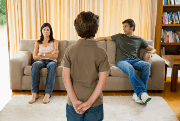 Child standing between parents during a custody discussion